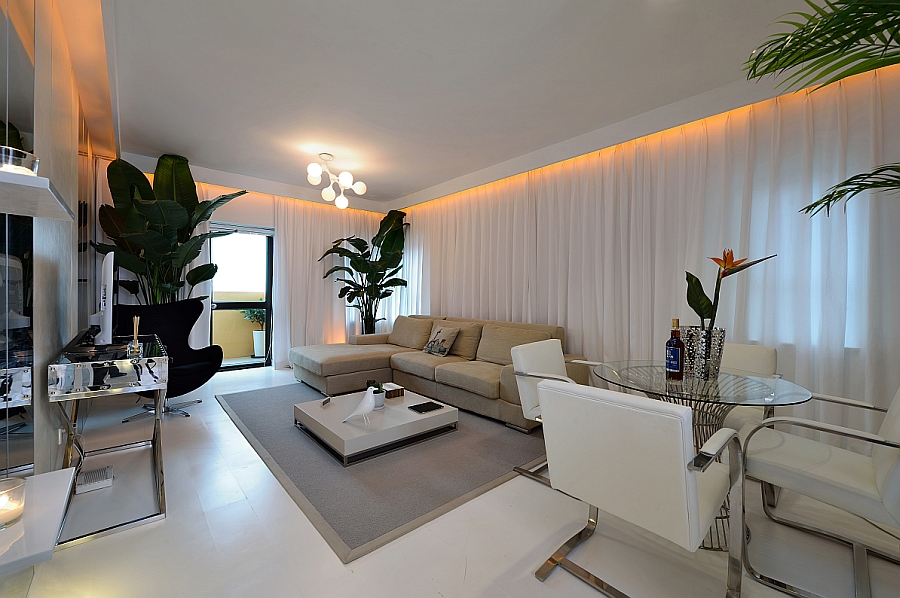 Goregous living room in white with orange LED lighting and a tropical touch