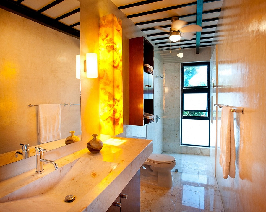 Gorgeous wall sconces in the bathroom light up the space about the vanity