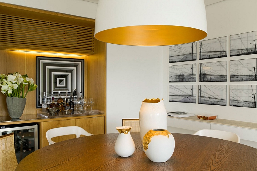 Interesting art work and accent lighting brighten the dining area