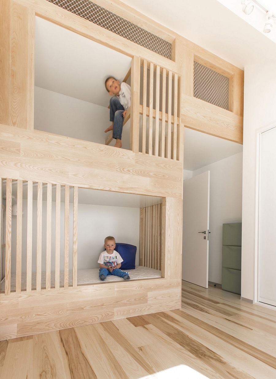 Kids' bunk beds that are built into the design of the loft apartment