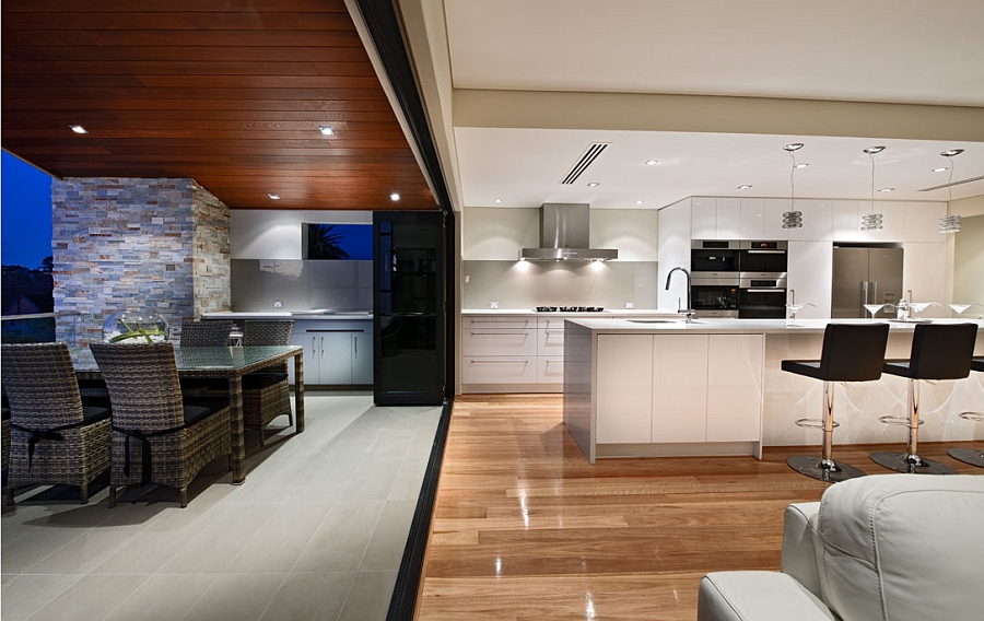 Kitchen conneted with the alfresco dining space using glass doors