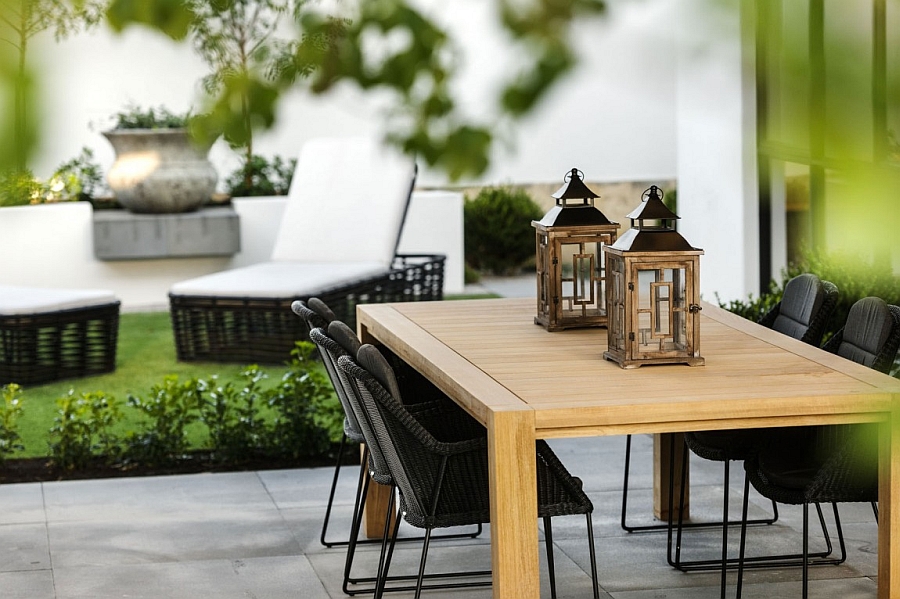 Lantern-styled lighting and decor in natural materials shape the outdoor