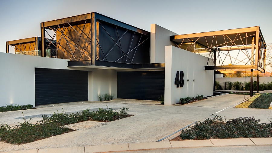 Large cantilevered boxes enclosed by black steel bars shape the South African house