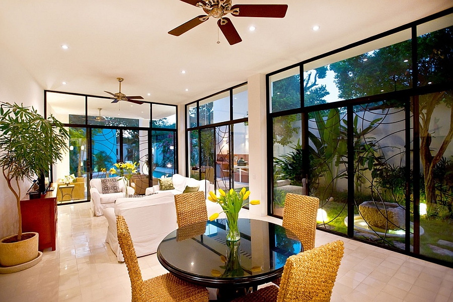 Large glass windows connect the living area with the beautiful backyard