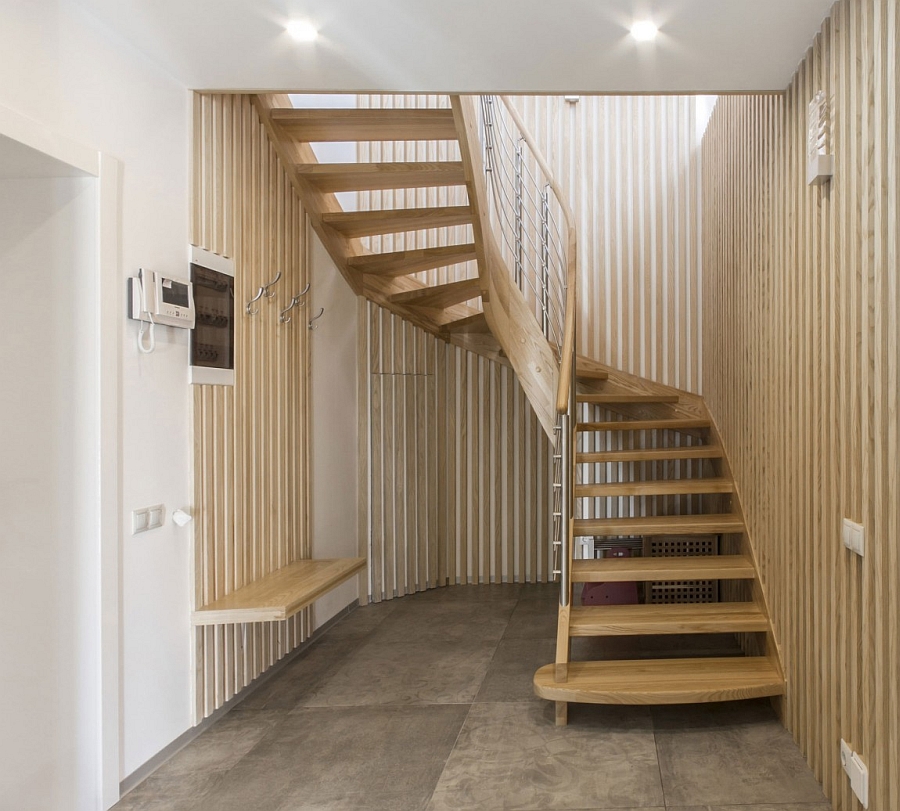 Light wood tones and sculptural staircase that saves up on space