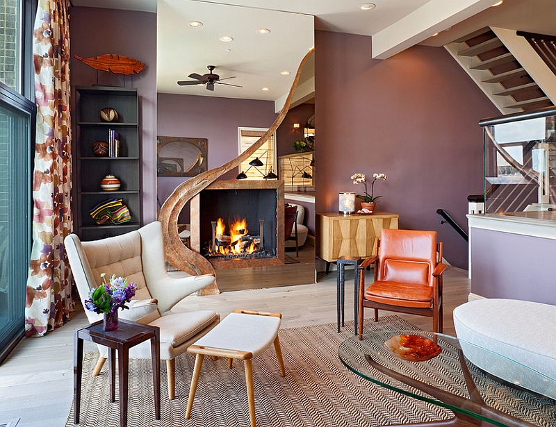 Lighter shade of eggplant and mirrored fireplace give the living room a warm, cozy vibe