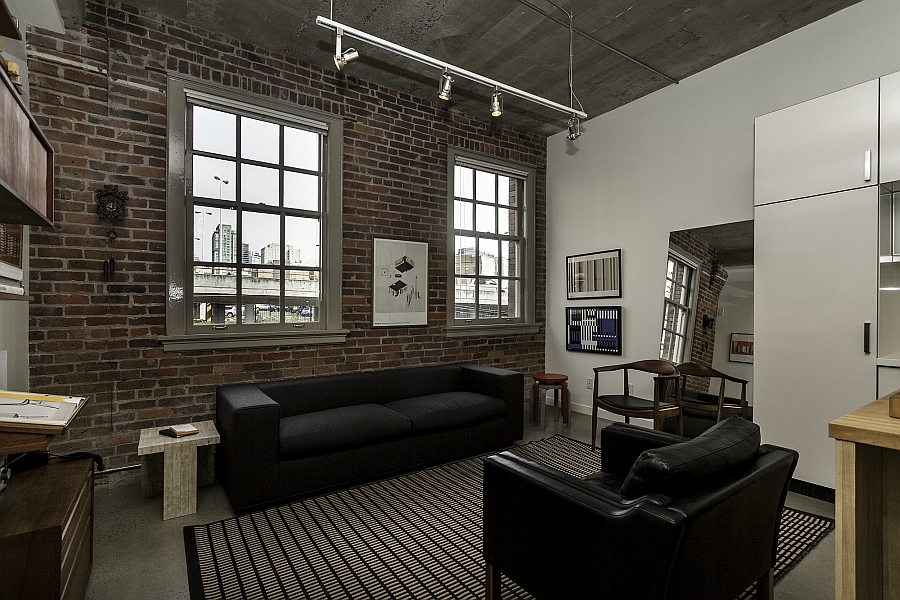 Living area of the loft with brick walls and plush decor