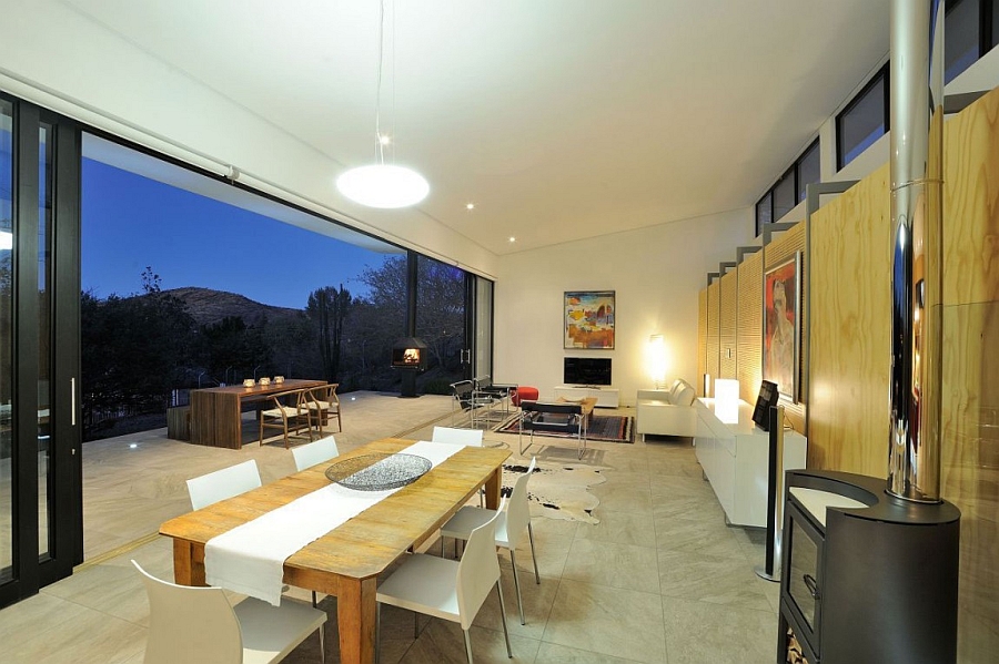 Living area opens up towards the concrete deck space thanks to the sliding glass doors