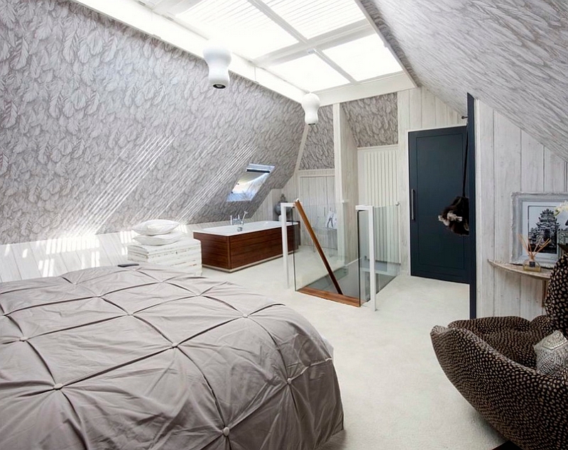 Loft bedroom with a standalone bathtub in the corner