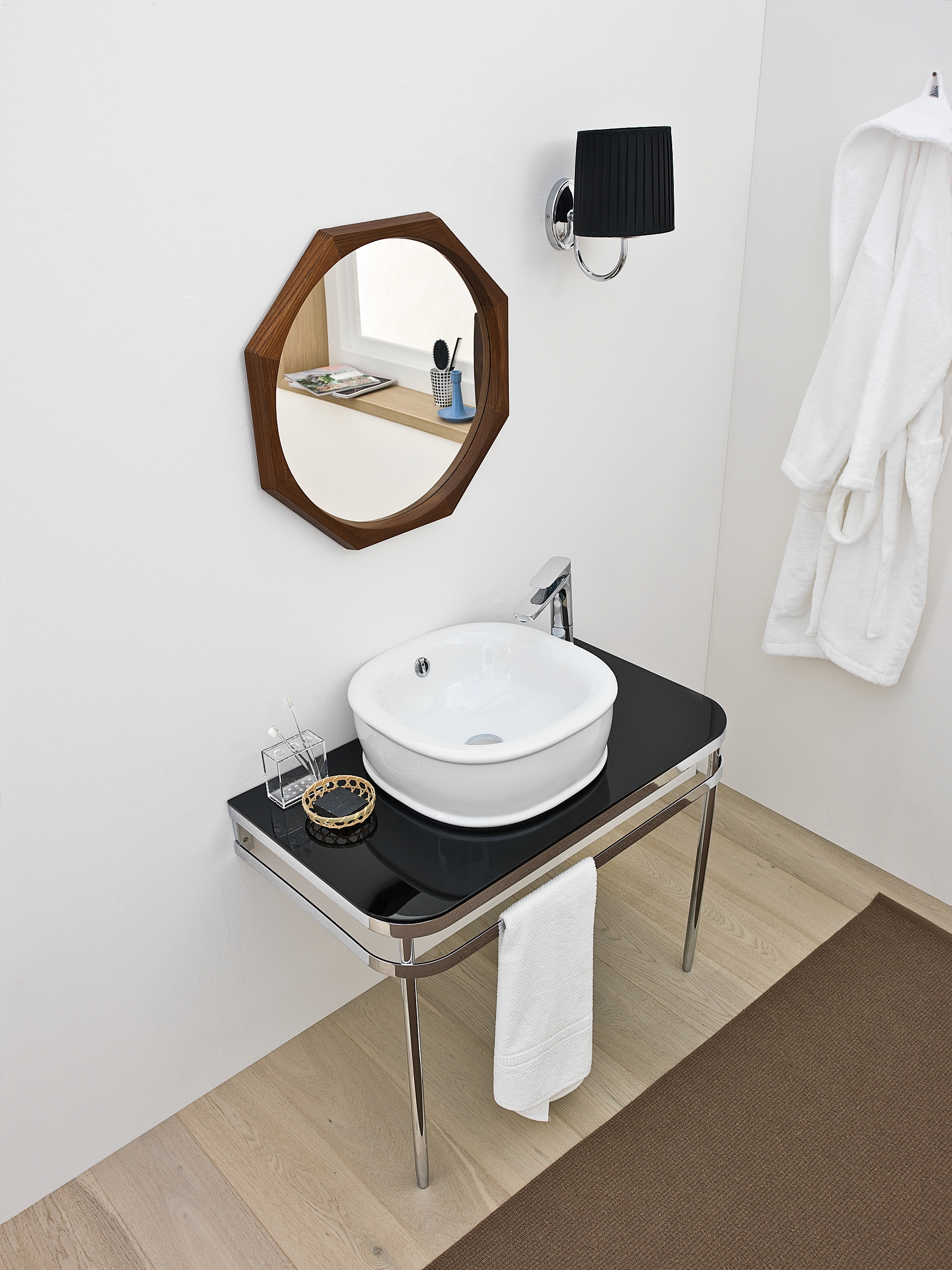 Lovely Azuley sink adds black hue to the trendy, white bathroom