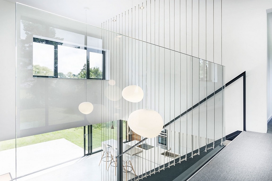 Lovely pendant lights illuminate the double height living area