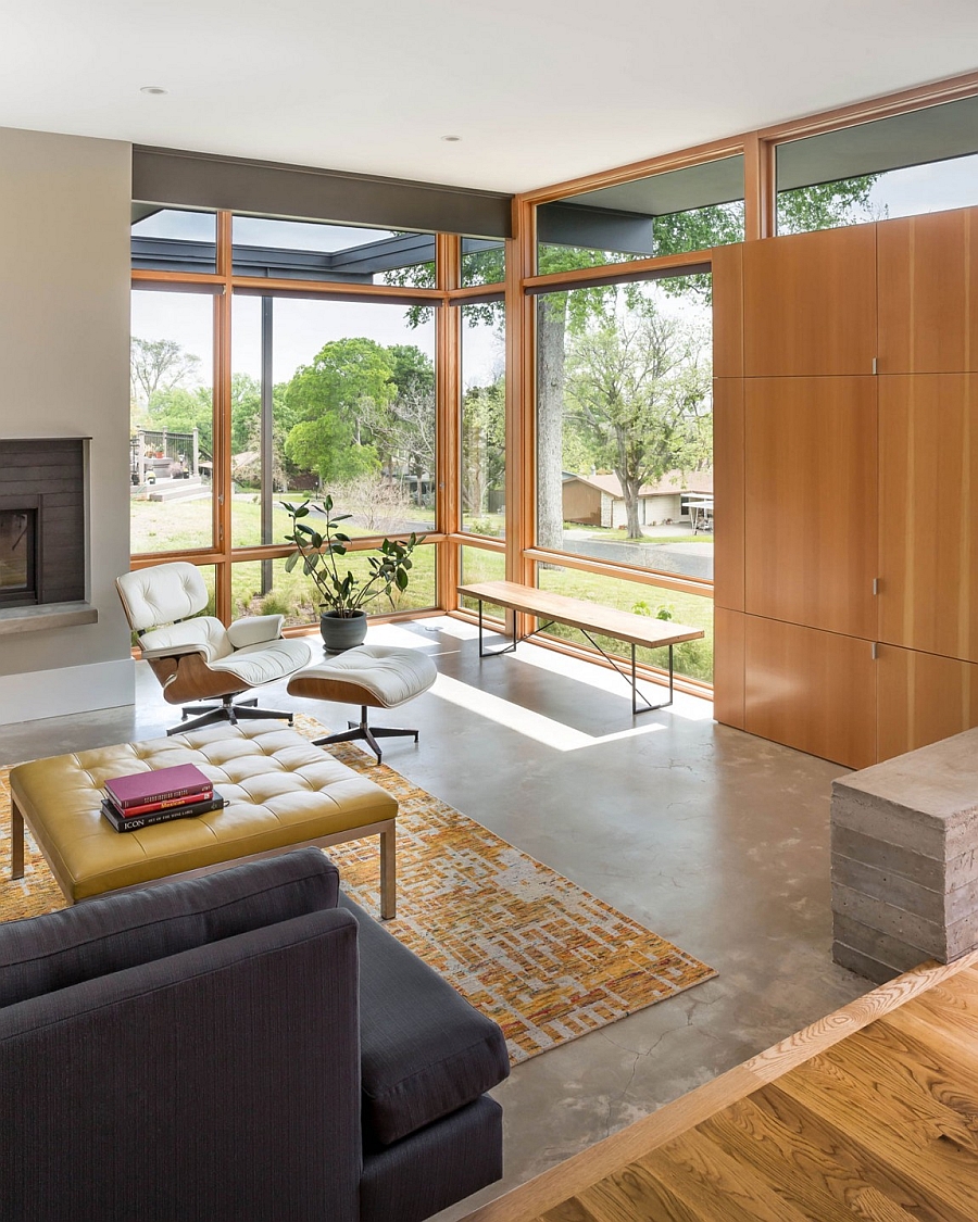 Luxurious Eames Lounger next to the fireplace offers a perfect reading nook