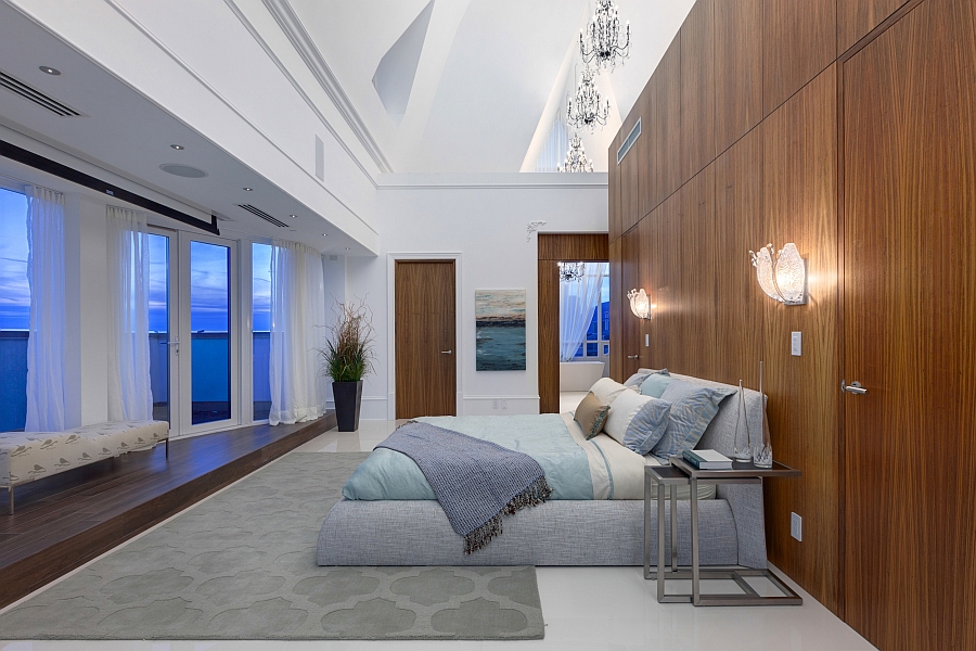 Luxurious master bedroom of the penthouse opens into the terrace outside