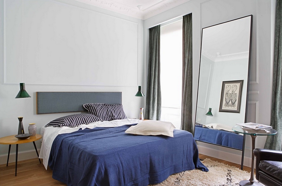 Masculine bedroom with understated bedside lighting and a midcentury style