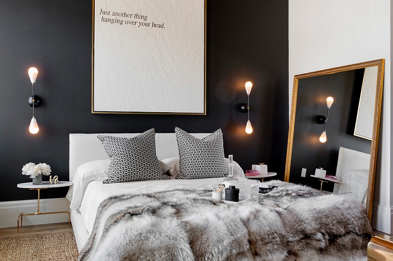 Mirror and lighting give the small bedroom a relaxed appeal despite the use of black