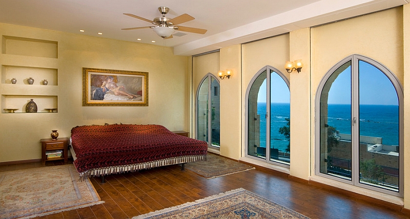 Moroccan style windows and fabric elevate the Mediterranean vibe of the beautiful bedroom