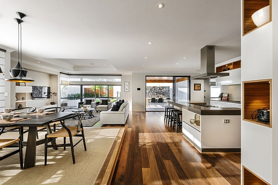 Open floor living area with the wishbone chairs and Tom Dixon lighting at the dining space