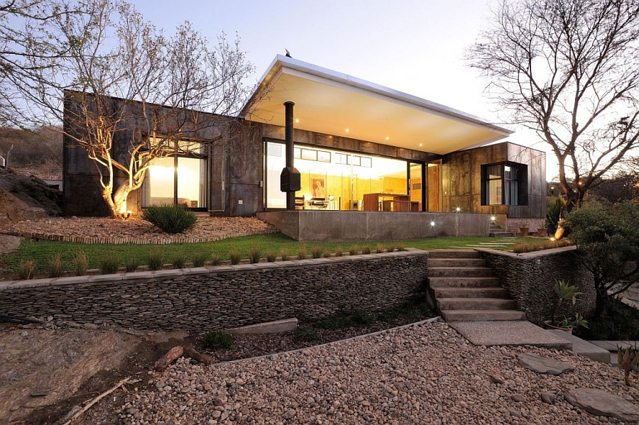 Outdoor fireplace and dining area add to the charm of the trendy African home