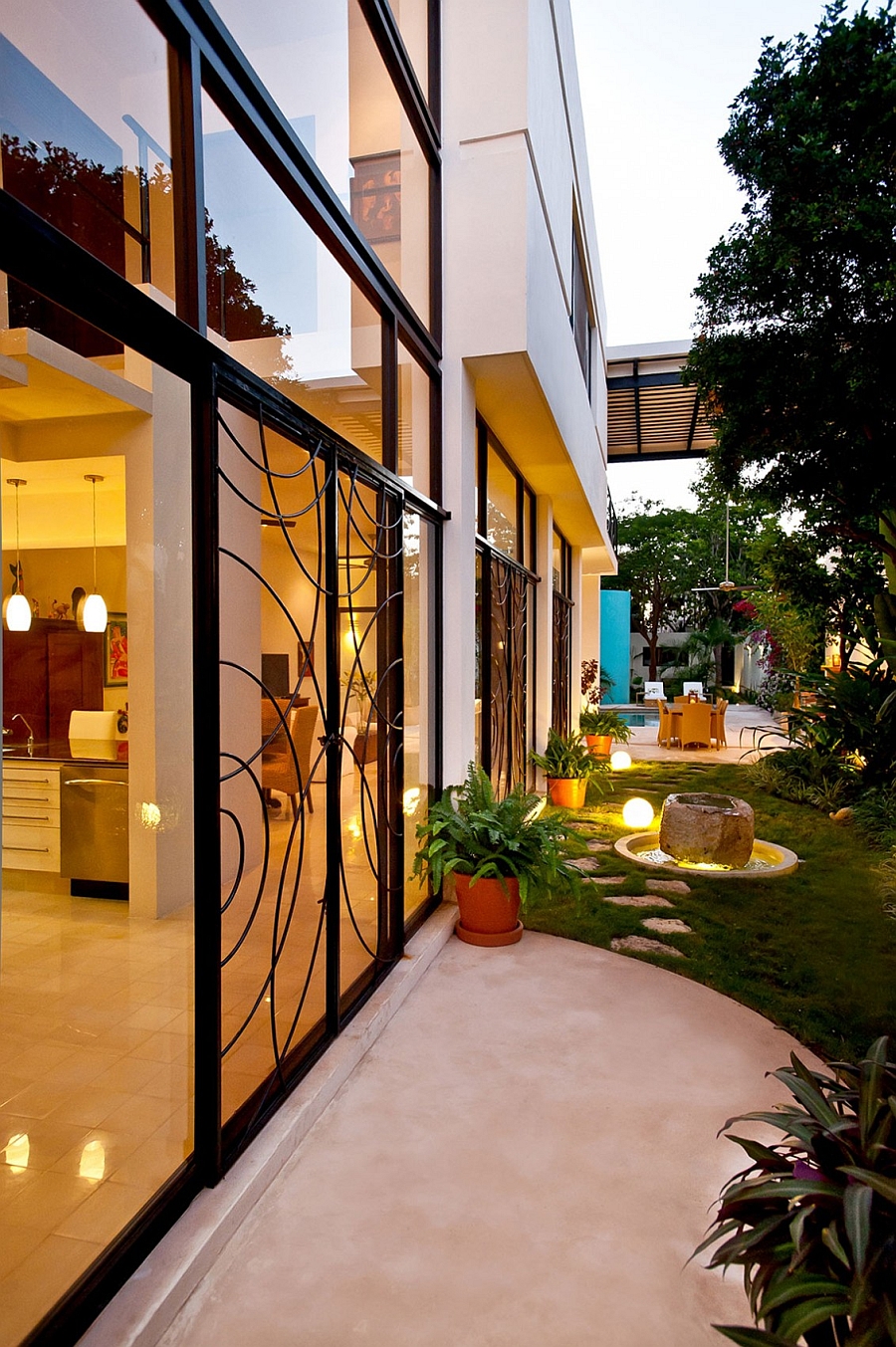 Outdoor lighting and intricate design on the sliding doors shape the beautiful landscape