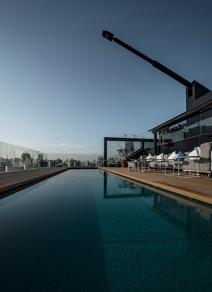 Outdoor terrace pool with two unique antenna style light fixtures above