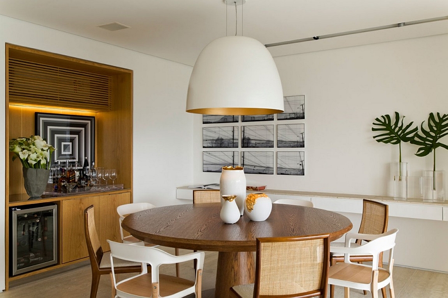 Oversized pendant above the dining table with a glint of golden yellow