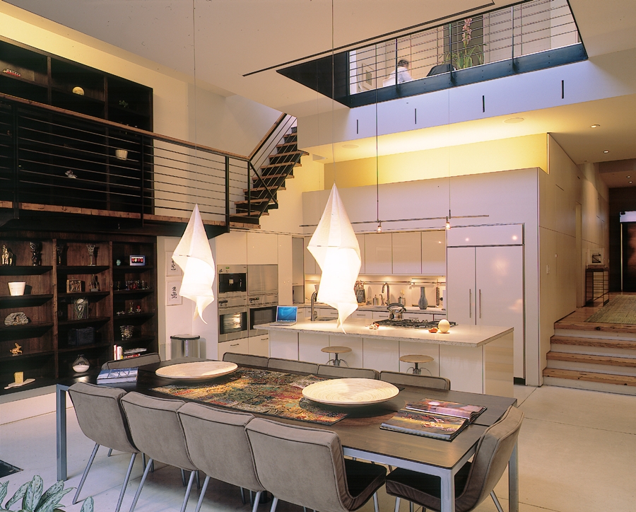 Pendant lights above the dining table appear like cool Halloween additions