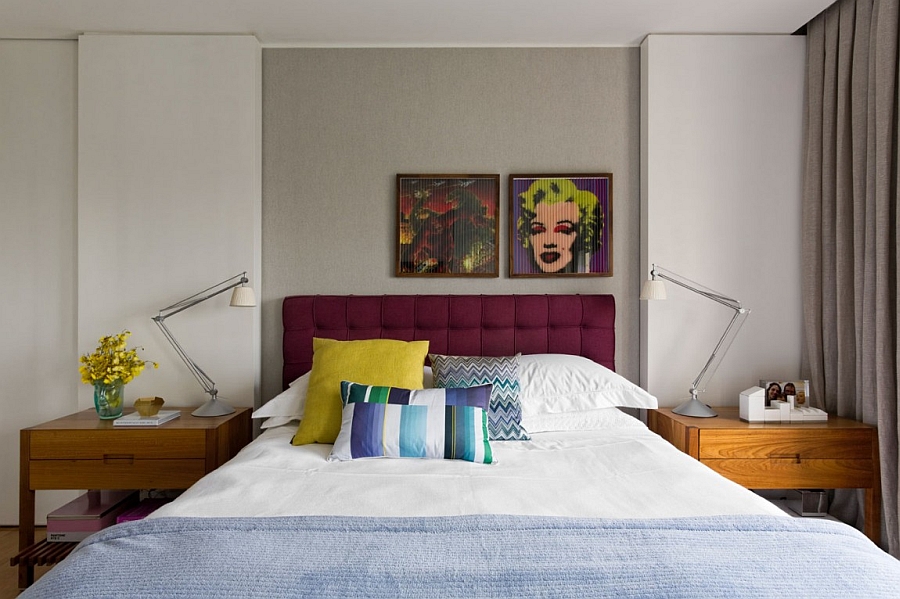 Plush headboard in purple and the portrait of Monroe add glam to the bedroom