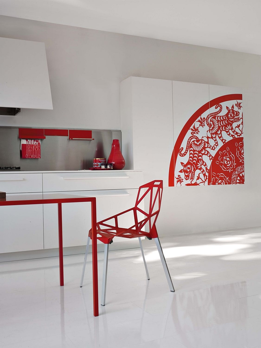 Sculptural decor additions and playful accents of red steal the show in this kitchen