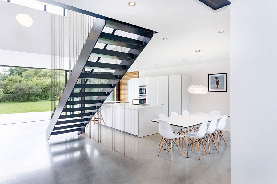 Sculptural staircase becomes the focal point of the lower level of Kilham House