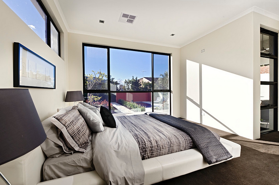 Serene and elegant bedroom in white with a viusally connectivity with the outdoors