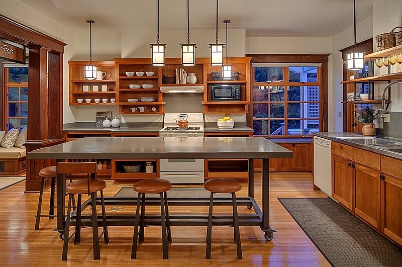 Simple color scheme, open shelves and the rolling kitchen island give the space an unassuming look