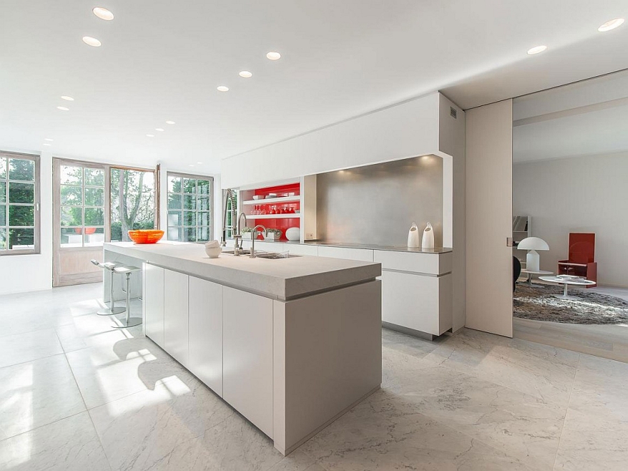 Sleek and spacious modern kitchen in white with a hint of red