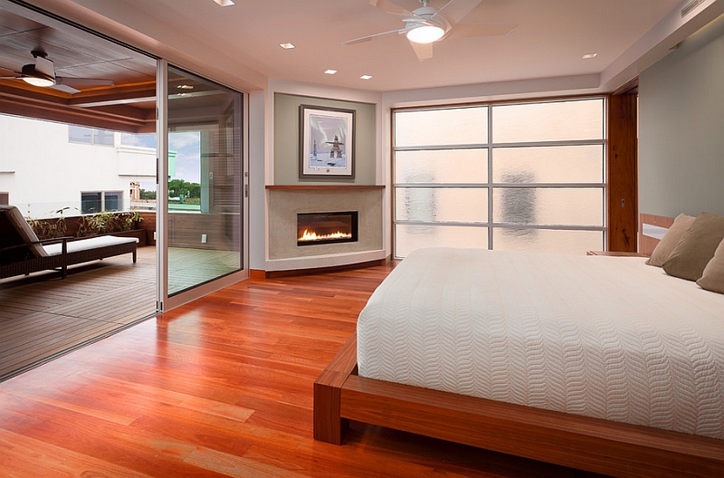 Sleek corner fireplace adds elegance to the serene bedroom