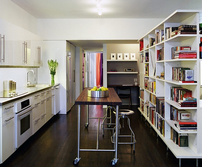 Sleek kitchen island on wheels occupies the slot between the counter and the bookshelf