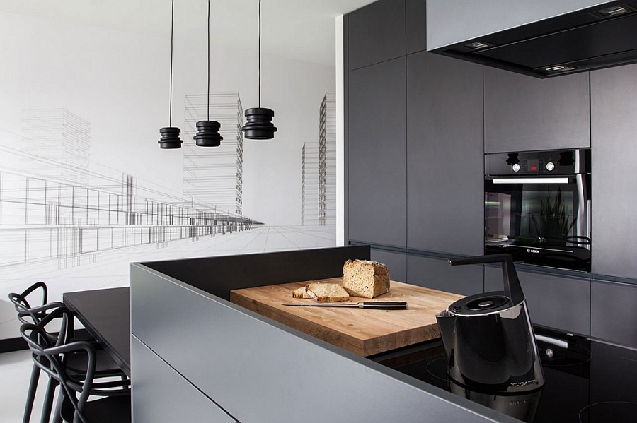Sleek, minimal kitchen island in grey and black with kitchen shelves in gray in the backdrop