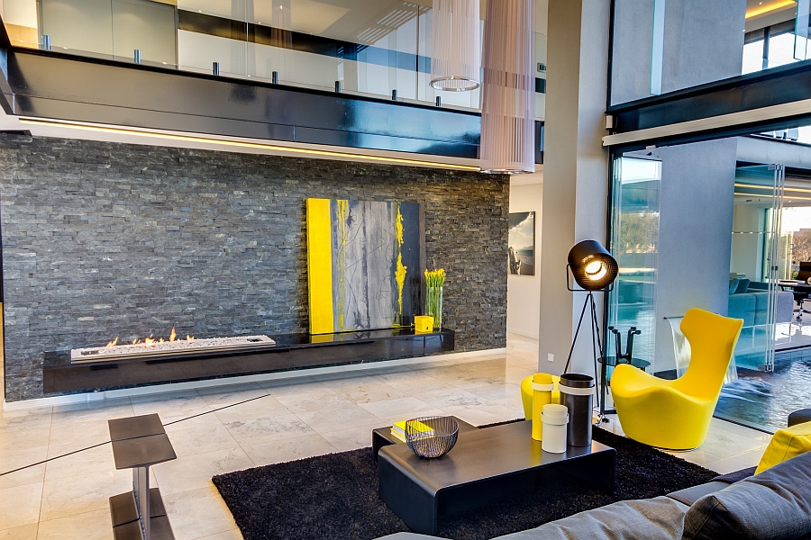 Sleek, modern fireplace and casually placed wall art lend sophistication to the room