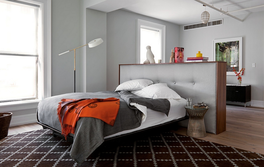 Small partition wall also acts as a beautiful tufted headboard in the bedroom