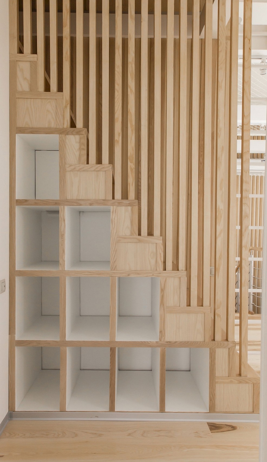 Small wooden shelves give additional display space to the small attic apartment