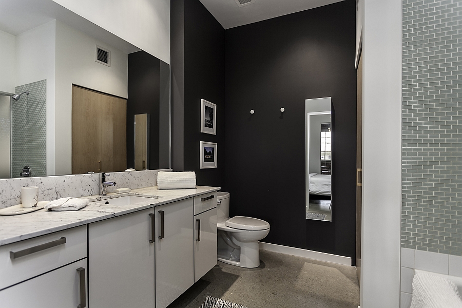 Spacious contemporary bath in black and white with a vanity that offers plenty of storage