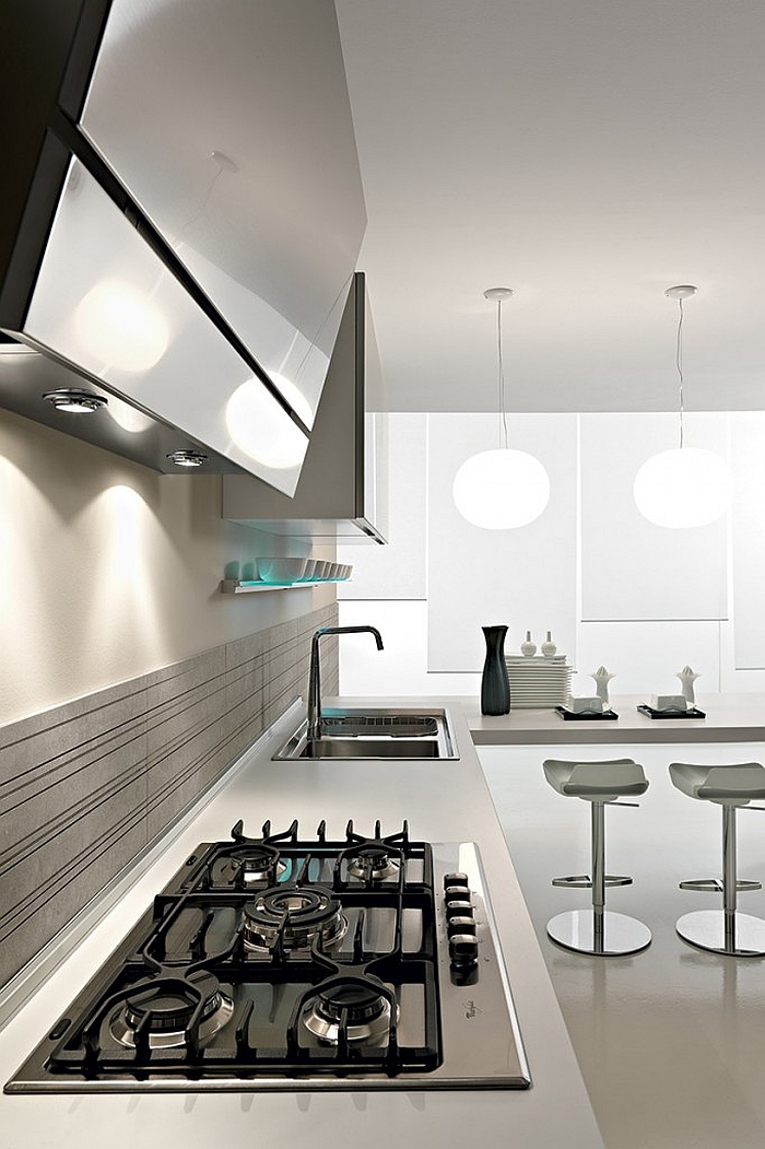 Stainless steel kitchen surfaces couple with white marble in a functional fashion