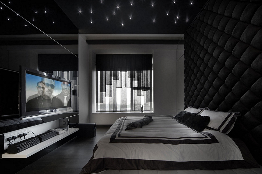 Stunning bedroom in black with tufted wall ceiling LED inserts and an expansive entertainment unit