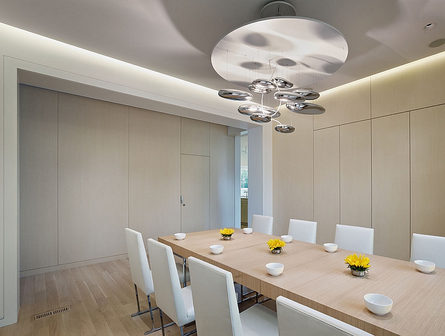 Stunning pendant light above the dining table adds metallic magic to the dining room