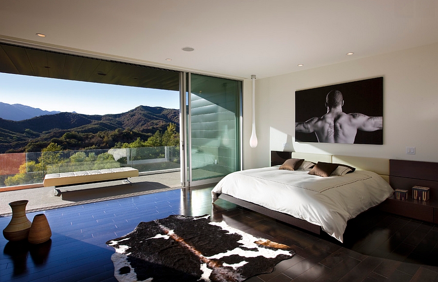 Stunning view outside instantly elevates the appeal of this gorgeous bedroom with a masculine style