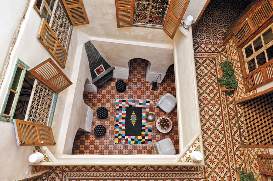 Top view of a stylish Moroccan courtyard with hand-painted tiles and colorful decor