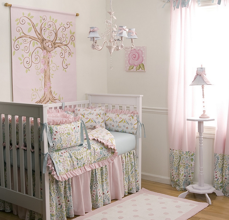 Use of intricate pattern and love birds decorative pillows compensates for the lack of bold colors in this chic pink nursery