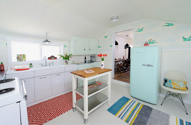 Vintage and retro design elements enliven this small kitchen with a rolling island