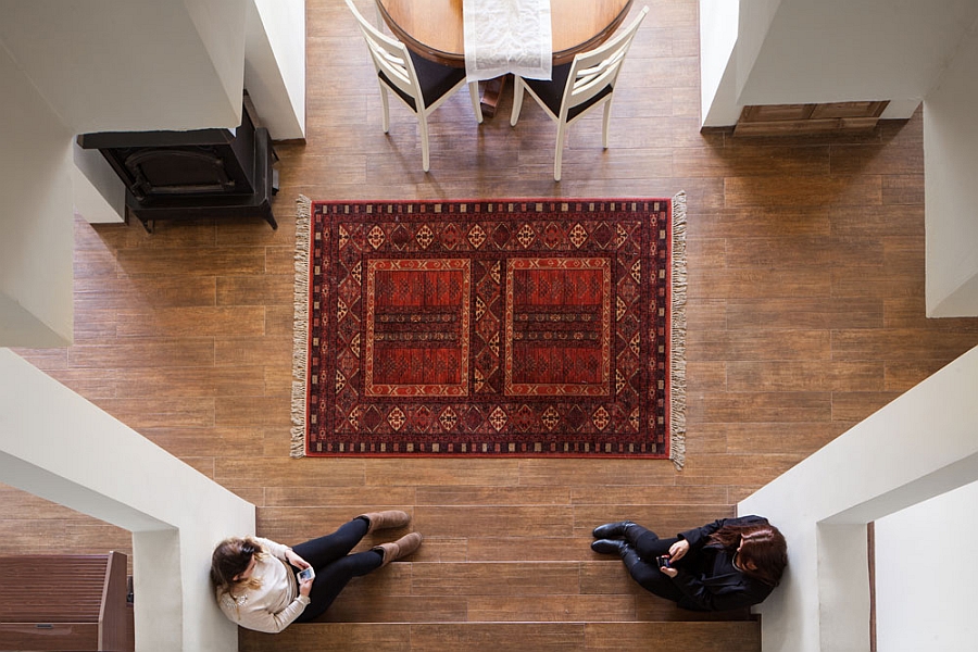 Beautiful use of rugs to infuse color into the elegantly renovated home