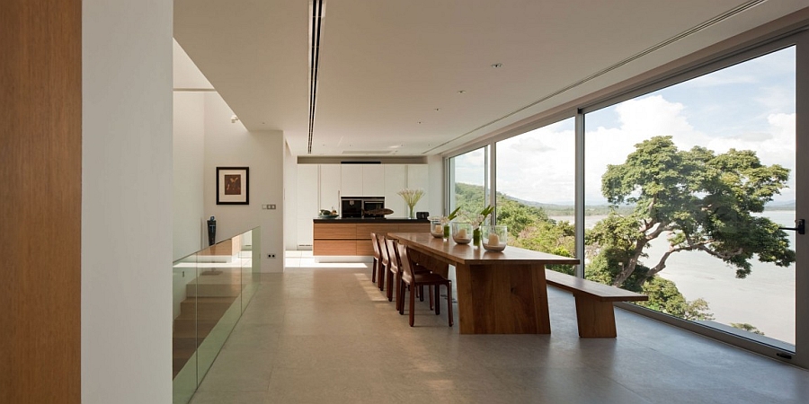 Dining room with glass walls opens up towards the sea