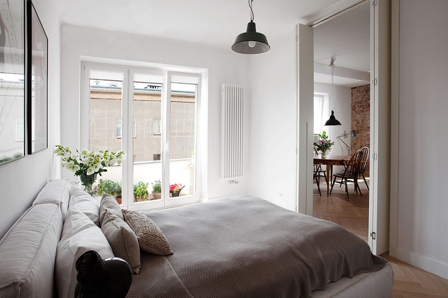 Folding doors and elegant use of glass doors gives the bedroom an airy appeal