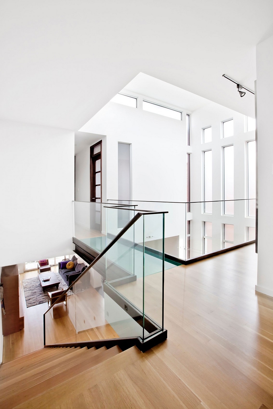 Glass staircase railing and walkway give the home an airy appearance